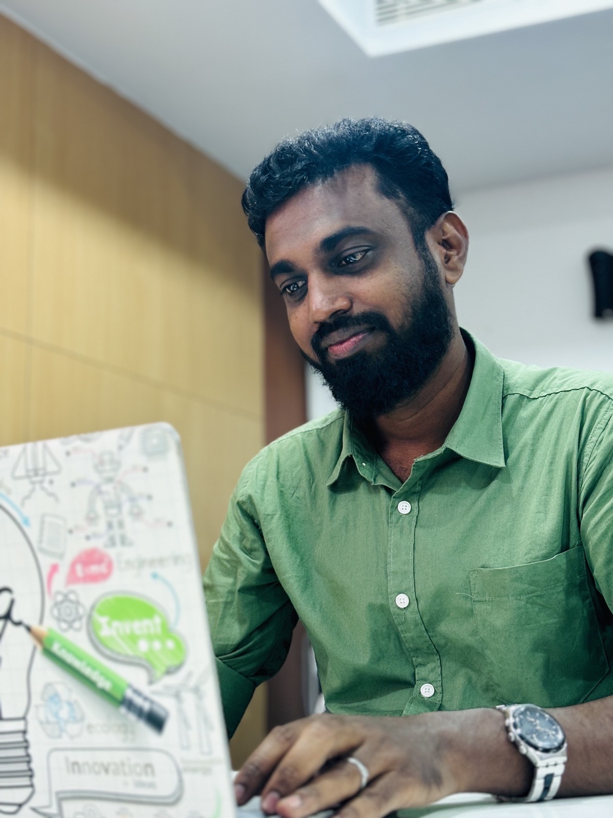 Umar Farook M working at his desk
